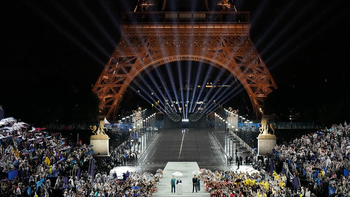 (AP Photo/David J. Phillip) : IOC President Thomas Bach speaks as Tony Estanguet, president of 2024 Paris Olympics looks on in Paris, France, during the opening ceremony of the 2024 Summer Olympics, Friday, July 26, 2024. 
